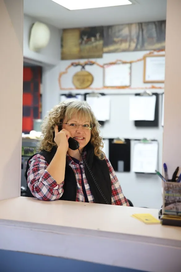 Chris Sommers taking a call at the shop counter